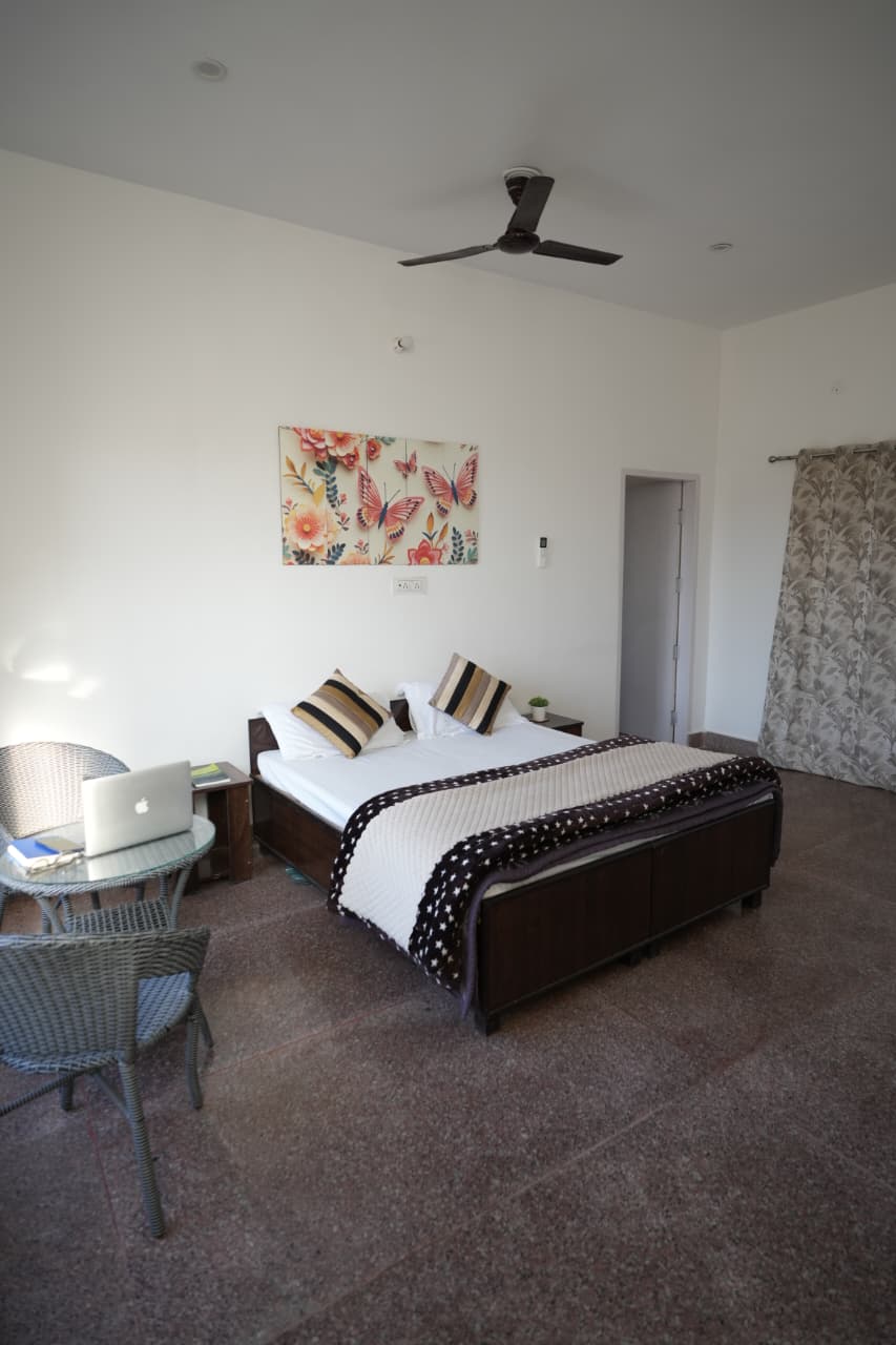 Private Family Villa — luxury 2-bedroom room with floor-to-ceiling valley view window and teal armchairs
